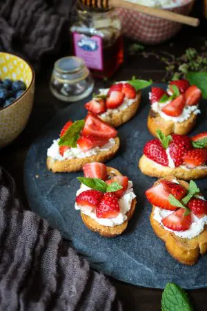 Topped with balsamic infused strawberries and ricotta cheese, this delightful appetizer or dessert is one of my favorite crostini recipes yet!