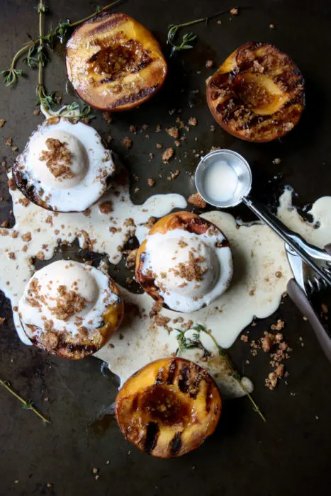 Grilled peaches with melted vanilla ice cream