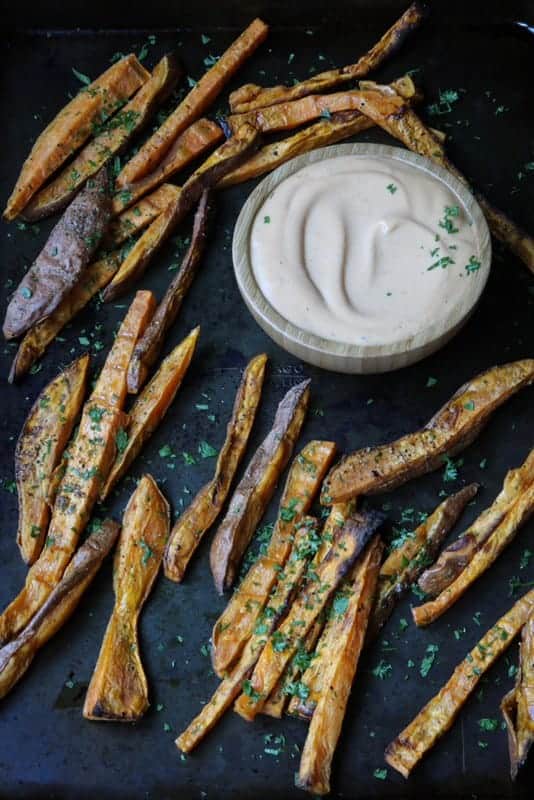 Sweet Potato Fries on serving tray with sauce