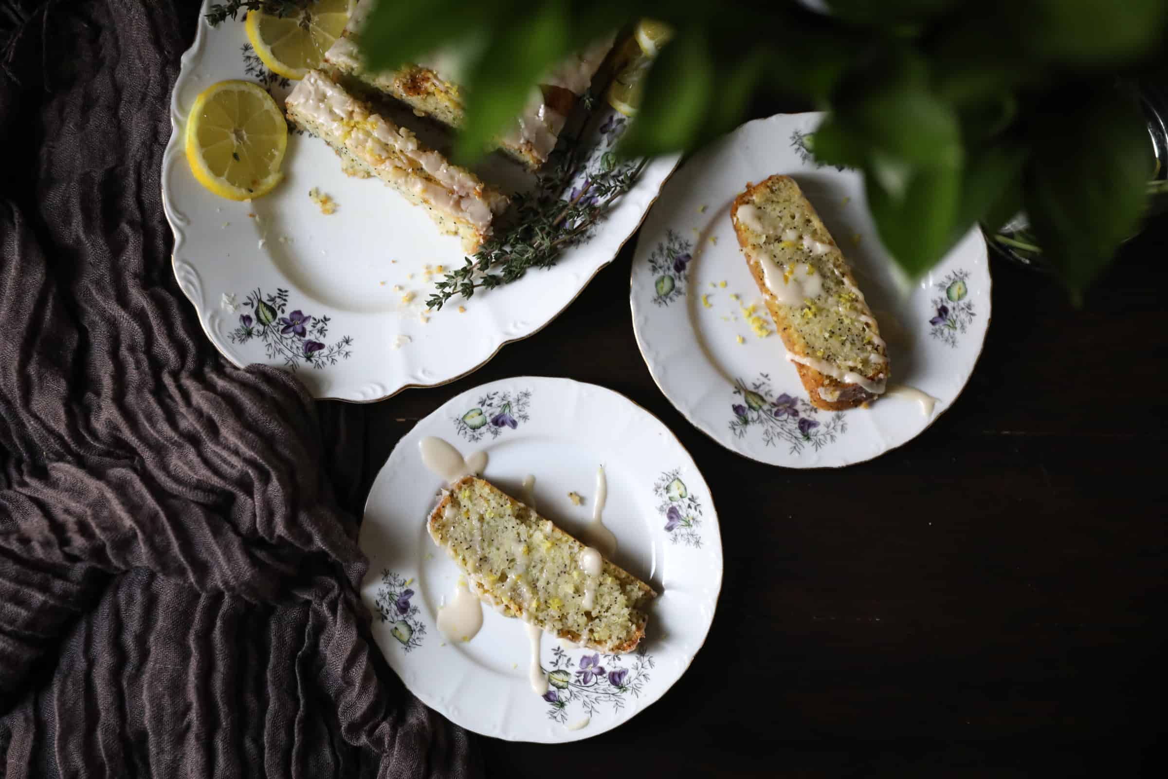 A group of plates with lemon poppy seed loaf slices